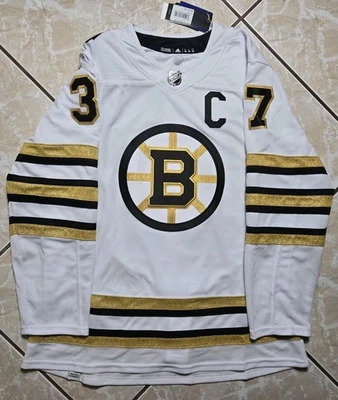 全新带标签阿迪达斯 Patrice Bergeron #37 波士顿棕熊队正品 NHL 百年纪念球衣 52 — 第 1/4 张图片