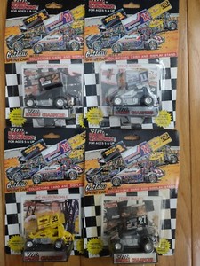 Four Racing Champion Outlaw Sprint Car with Collectors Card and Stand