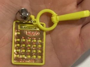VTG Yellow SHARP Calculator Clip On Charm with Bell For Plastic Necklace1980s - Picture 1 of 2