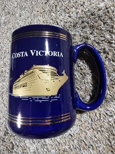 Taza de café Costa Victoria azul y dorado - Imagen 1 de 6