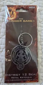 NEW SEALED THE HUNGER GAMES DISTRICT 12 SEAL METAL KEYCHAIN - Picture 1 of 6