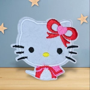 HELLO KITTY PINK AND RED BOW AND DRESS CARTOON CHARACTER IRON ON PATCH - Picture 1 of 2