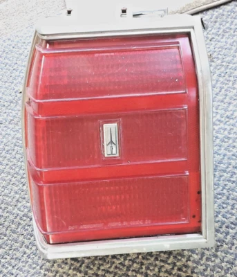 1981-82 Oldsmobile Delta 88 Royale LH Taillight Lense with Chrome Bezel Housing - Image 1 of 4