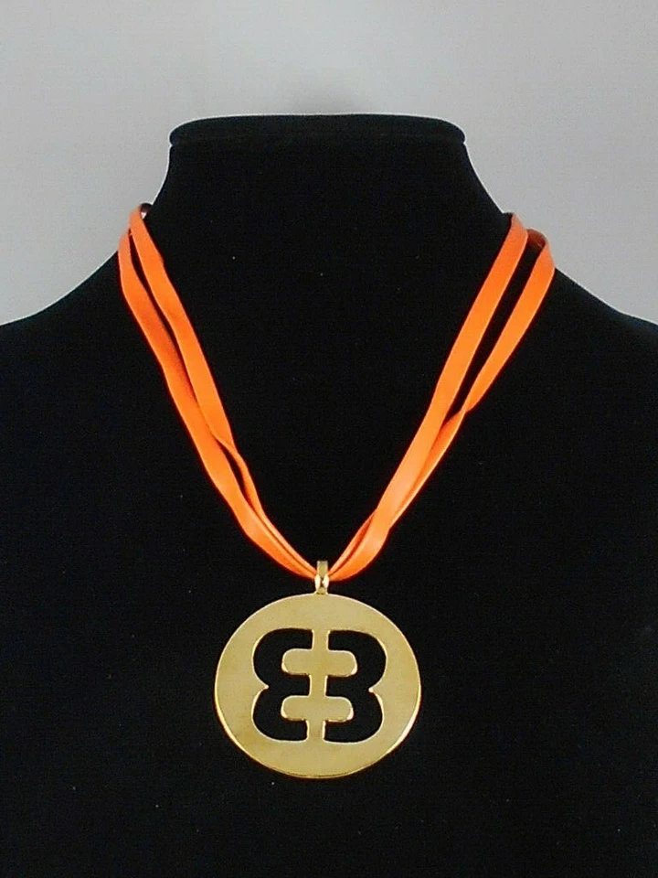 Betsey Johnson Goldtone Status Orange Faux Leather Cutout Emblem Necklace