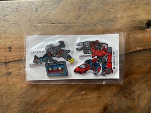 Transformers G1 Jotastar Glitzer Aufkleber Paar - Laserbeak/Sideswipe - versiegelt - 1985 - Bild 1 von 6