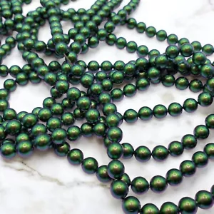 Paquete de 50 perlas verdes escarabajo cristal Swarovski redondo de 6 mm (5810) - Imagen 1 de 5