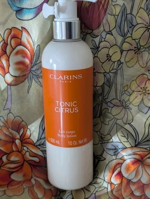 Loción corporal cítrica Clarins Paris Tonics 10 oz. Foto 1 de 2