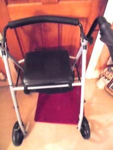 LIGHTWEIGHT FOLDABLE ALUMINIUM WALKING FRAME ROTATING WHEELS,BRAKES,PADDED SEAT. - Picture 1 of 9