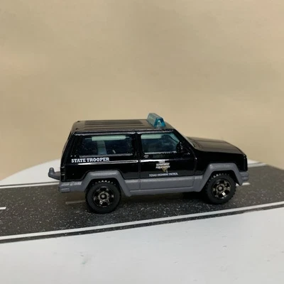 2018 Matchbox Texas Patrol Jeep Cherokee XJ Black State Trooper Police 1:64 NM - Image 1 of 4