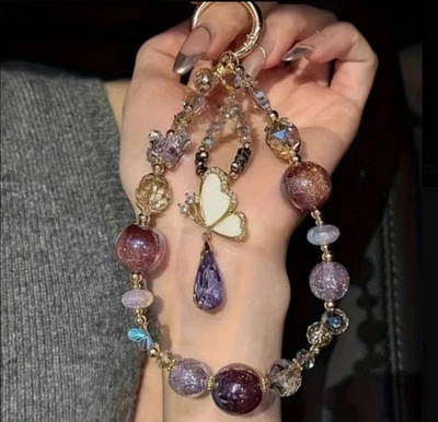 Elegante bolso de teléfono con cuentas rosa púrpura de diamantes de imitación con correa de muñeca  Foto 1 de 4