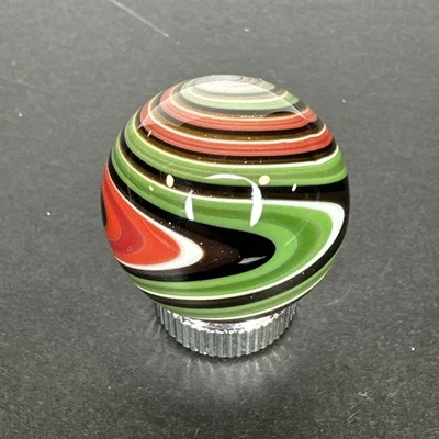 Contemporary Handmade Art Glass Marble .95" Wigwag W/ Green, Red, Black, White - Image 1 of 4