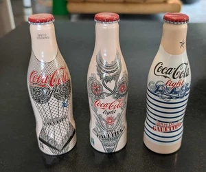 3 bouteilles pleines de Coca Cola  par Jean Paul Gaultier - Picture 1 of 1