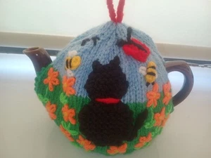 HAND KNITTED TEA COSY FOR SMALL TEAPOT -CAT IN THE MARIGOLDS - Picture 1 of 5