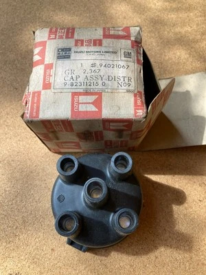 Vintage OEM ISUZU / GM Ign. Tapa de distribuidor, #94021067, NOS, embalaje de fábrica. Foto 1 de 4