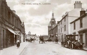 REAL PHOTO POSTCARD OF THE HIGH STREET, LOCKERBIE, DUMFRIESSHIRE, SCOTLAND - Picture 1 of 2