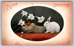 Saluti di Pasqua, Scarpe di legno nido di uova, coniglio, gigli, cartolina antica - Foto 1 di 2