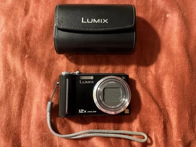 Cámara digital Panasonic LUMIX DMC-ZS1 12X zoom negro cubierta de batería rota Foto 1 de 4