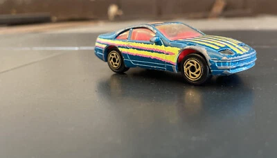 Nissan 300ZX 1990 Matchbox vintage verde azulado/rosa escala 1/64 fundido a presión TAILANDIA Foto 1 de 4