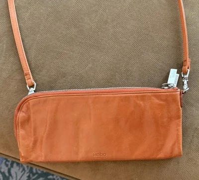 Bolso sin asas forrado de cuero naranja HOBO International Foto 1 de 4