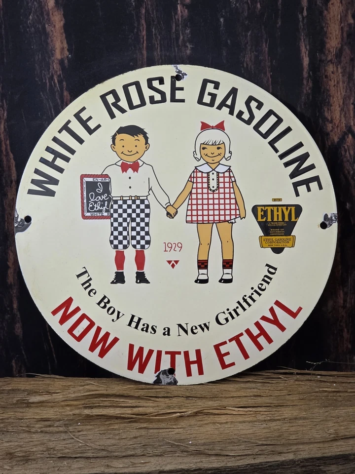 "LETRERO DE PORCELANA VINTAGE DE GAS ROSA BLANCA AHORA CON ACEITE ETÍLICO GASOLINA 12""" Foto 1 de 4
