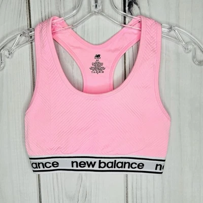 Sujetador deportivo New Balance rosa espalda cruzada ropa deportiva talla S acanalado tejido logotipo Foto 1 de 4