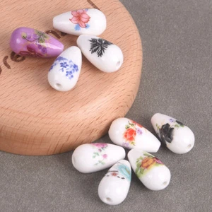 Lotto perline sfuse porcellana ceramica forma lacrima 10 pezzi motivi floreali 10x20 mm - Foto 1 di 13