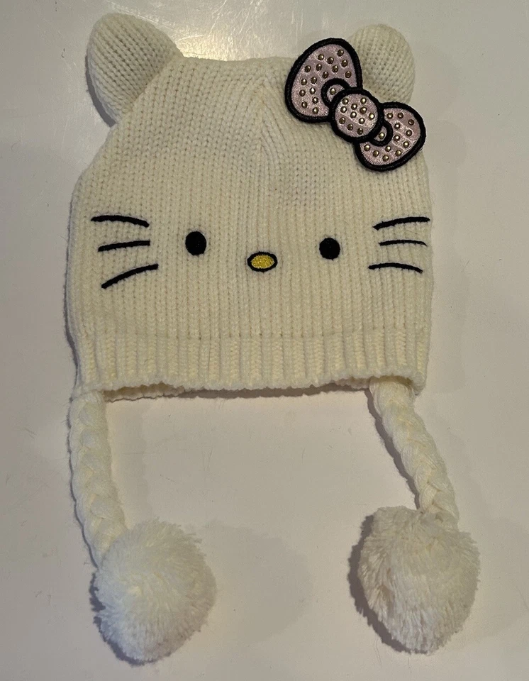 Gorra gorro tejido con cable lazo blanco rosa Hello Kitty niñas talla 4-14 con pompones colgantes Foto 1 de 4