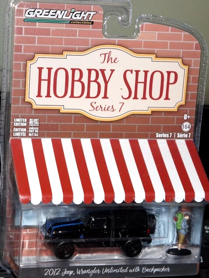 Greenlight 1/64 2012 Jeep Wrangler Unlimited Backpacker Diorama Hobby Shop Black - Image 1 of 1