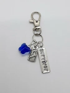 Backpack/keychain survivor series/child abuse awareness  - Picture 1 of 3