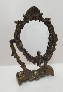 Espejo de tocador giratorio ovalado ornamentado de latón vintage con querubín - Imagen 1 de 15