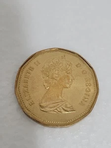 MONEDA DE UN DÓLAR DE COLECCIÓN 1987 ELIZABETH 11 D.G. REGINA COLOR ORO SIN CERTIFICAR... - Imagen 1 de 4