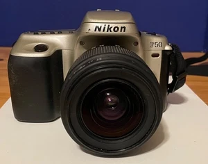 NIKON F50 silver SLR 35mm camera with Promaster Lens 1:3.5-5.8 28-80mm - Picture 1 of 8