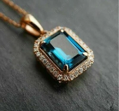 Cadena colgante con halo de topacio azul y diamante simulado de 2,50 quilates acabado en oro rosa de 14 quilates Foto 1 de 4