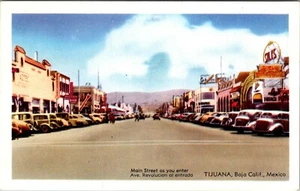TIJUANA, BAJA CALIFORNIA, MEXICO - BUSY MAIN STREET AS YOU ENTER - OLD POSTCARD - Picture 1 of 2