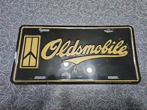 Vintage Oldsmobile Booster License Plate Black And Gold. Nice For The Age. Used. - Picture 1 of 9