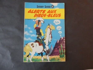 MORRIS LUCKY N°10 ALERTE AUX PIEDS- BLEUS REEDITION DOS JAUNE DE 1964 - Picture 1 of 8