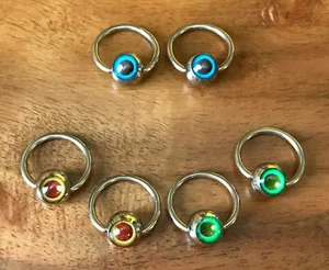 10 pezzi anelli perline prigioniere logo bulbo oculare ingrosso CBR gioielli corpo - Foto 1 di 4