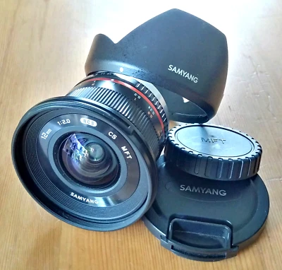 Samyang 12mm f/2 NCS CS Ultra Wide Manual Focus Camera Lens for MFT + Hood, Caps - Image 1 of 4