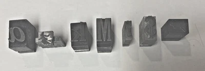7 Separate Letterpress Lead Type Blocks: a, Witch, k, M, ? Mark,Crown/cross, $ - Image 1 of 4