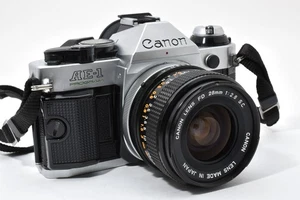 [COMO NUEVA] Cuerpo de programa Canon AE-1 35 mm SLR cámara fotográfica plateada + FD 28 mm f/2,8 s.c. sc - Imagen 1 de 24