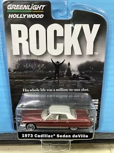1/64 GREENLIGHT HOLLYWOOD ROCKY 1973 CADILLAC SEDAN DeVILLE BROWN & WHITE TOP - Picture 1 of 2