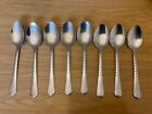 A Set of Eight Shiny Stainless Steel Dessert Spoons.