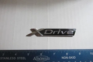 Emblema BMW X-Drive 2004-2010 de fábrica - Imagen 1 de 4