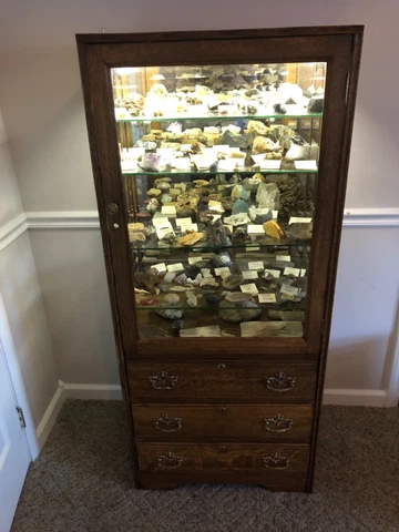 antique oak medicine cabinet with rock and fossil collection Cover