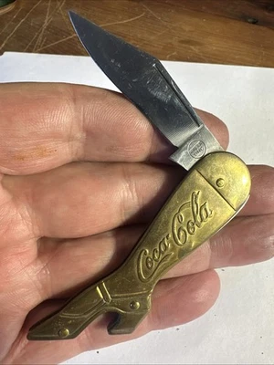 CUCHILLO BOTA PUBLICIDAD VINTAGE REMINGTON UMC COCA COLA, LATÓN E INOXIDABLE Foto 1 de 4