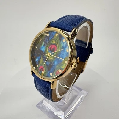 Reloj de cuarzo con esfera de pluma de pavo real de 37 mm de acero inoxidable tono dorado para dama Foto 1 de 4