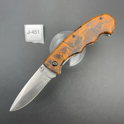 Cuchillo asistido por resorte Elk Ridge 7" mango naranja camuflaje con clip Foto 1 de 4