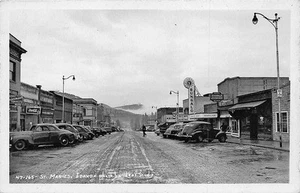 St. Maries ID Dirt Street Bungalo Theatre Movie Marque Stores Cars RPPC Postcard - Picture 1 of 3