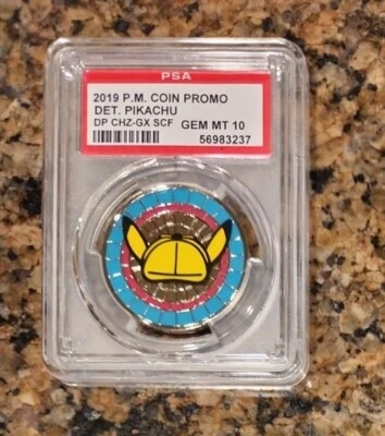PSA 10 DETECTIVE PIKACHU CHARIZARD GX CASE FILE METAL COIN PROMO 2019 POKEMON - Image 1 of 2