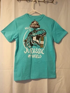 Camicia Welcome To Jurassic World Universal Studios nuova ragazzo/bambino XL (14-16) - Foto 1 di 7